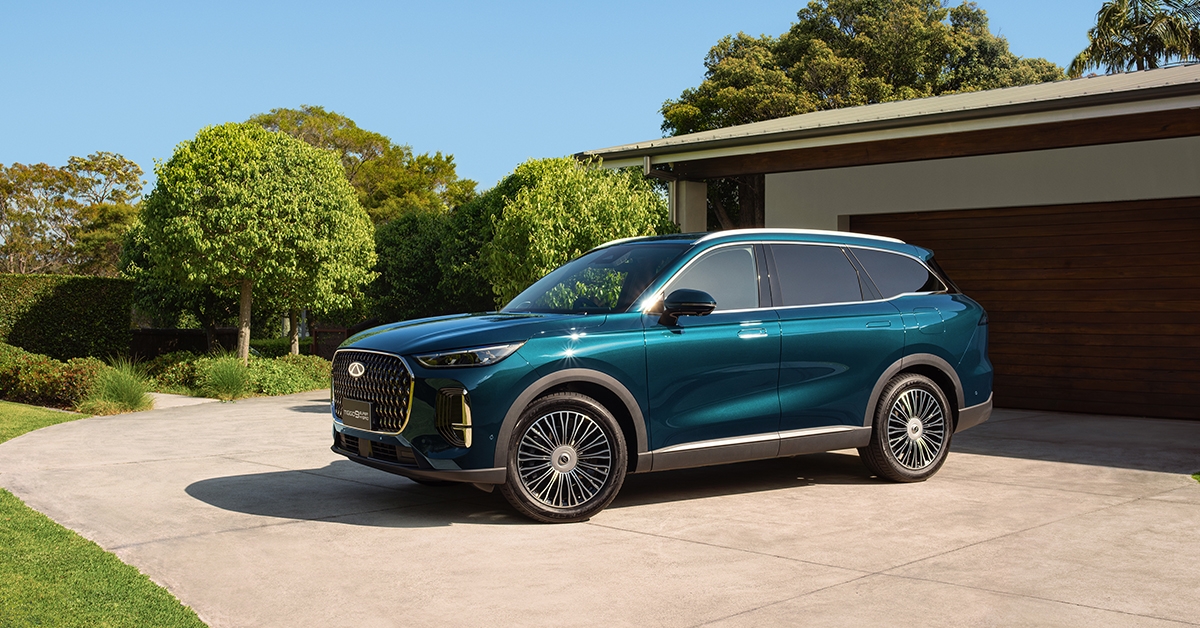 Chery Tiggo 9 in green outside a garage