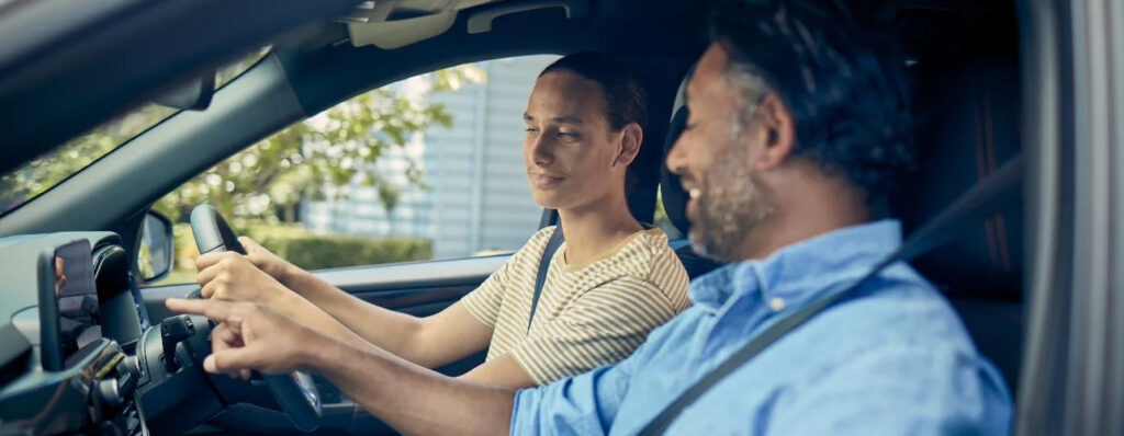 A salesman showing a customer how to use a ford