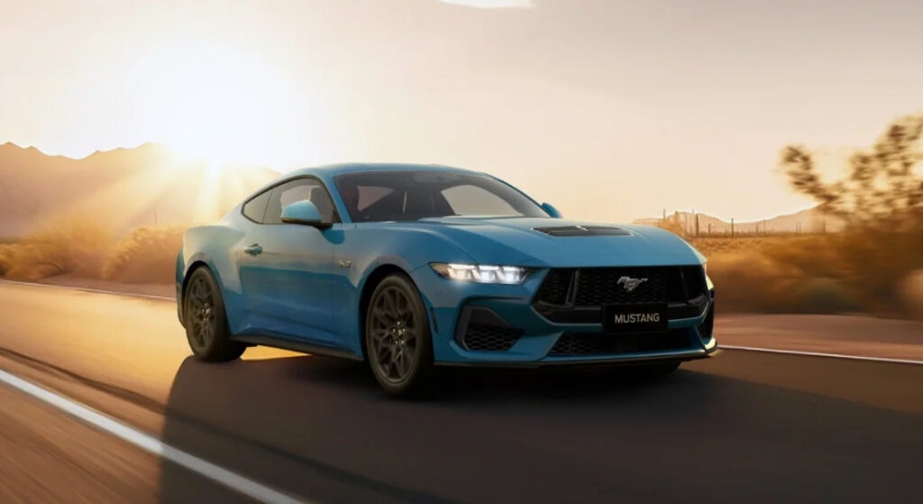 2025 Ford Mustang Convertible cruising New Zealand coastline at sunset