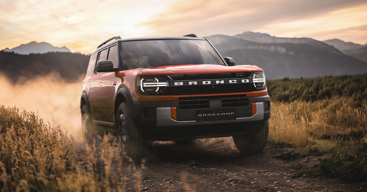 Wolftrak, Tremor and 2026.5MY Black Edition shown. Orange 2027 ford bronco basecamp driving offroad