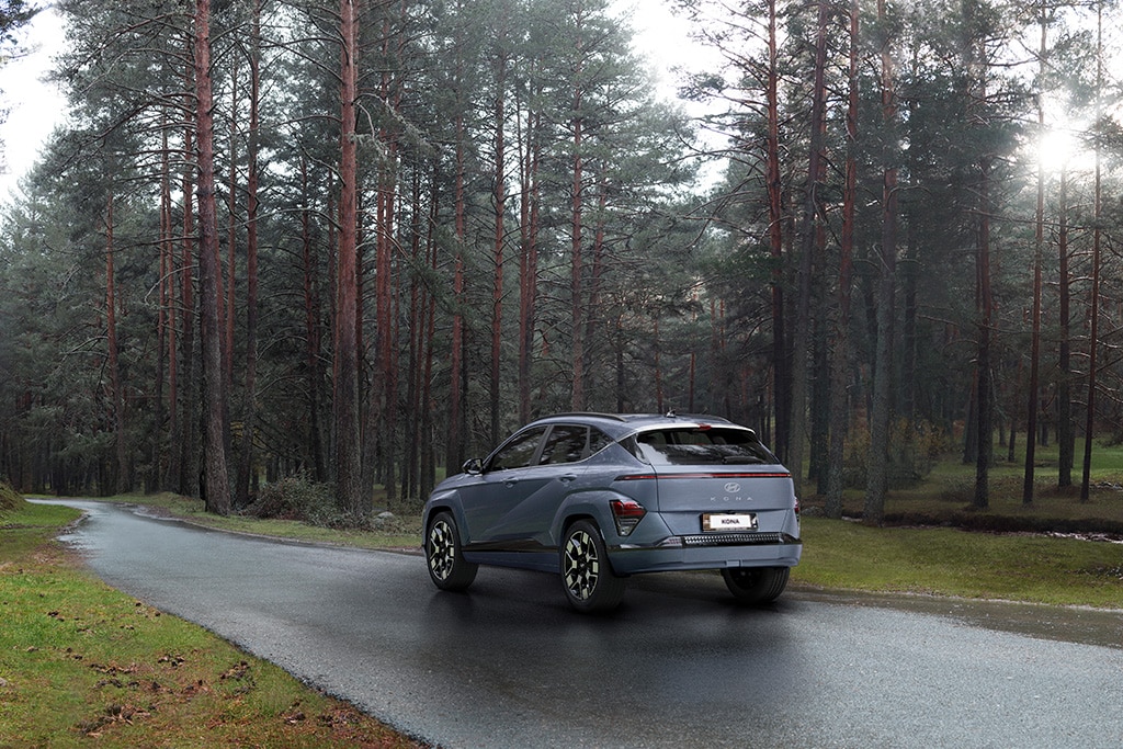 All-new Hyundai KONA Electric driving through forest 