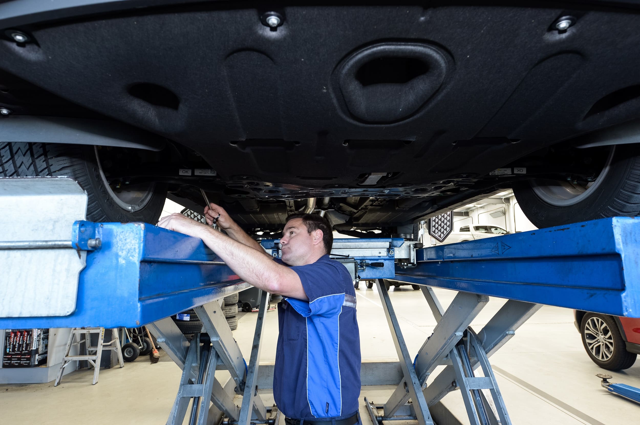 Ingham Automotive technician inspecting wheels