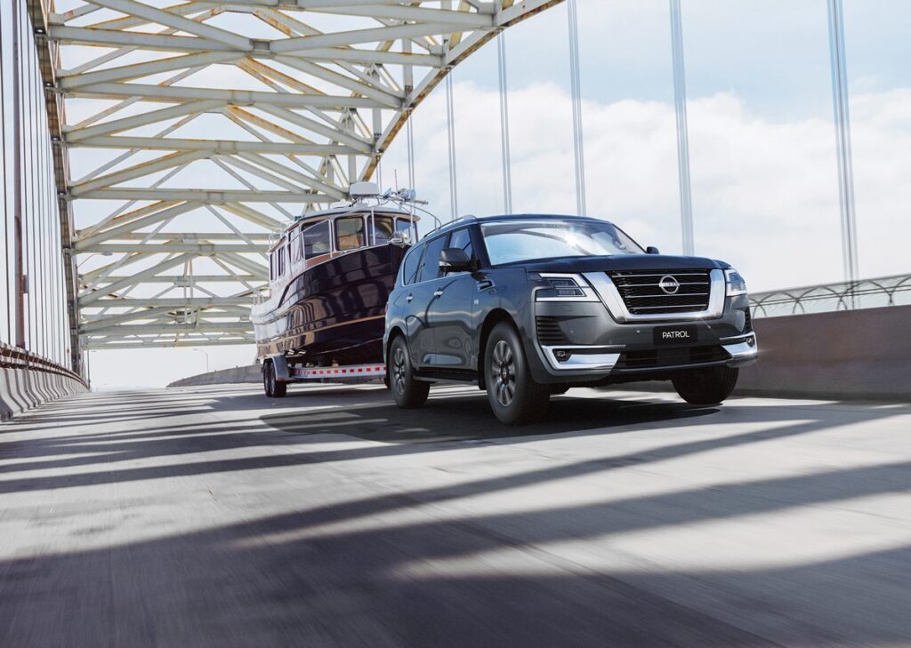 New Nissan Patrol towing a boat over a bridge
